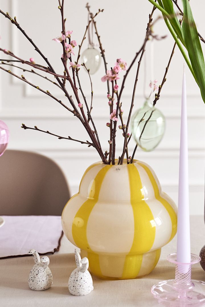 Crea un árbol de Pascua en casa con jarrones coloridos, como el jarrón Curlie en amarillo de By On o el jarrón Dorit de Broste Copenhagen.