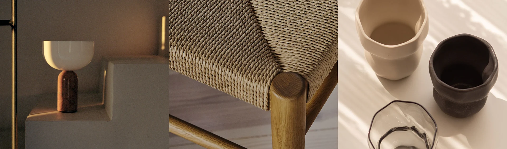 Una lámpara moderna, un asiento de silla trenzado y dos tazas de cerámica con un cuenco de cristal, todo en tonos cálidos.