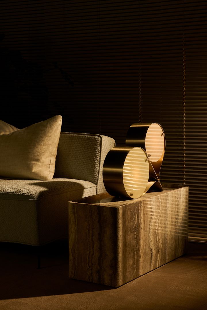 Las tendencias de diseño de interiores de otoño de 2024 son una mezcla de alegría y vibraciones retro. Aquí puedes ver el jarrón Lori de Byon en azul con peonías de color rojo intenso, sobre la mesa auxiliar Burf de Ferm Living.