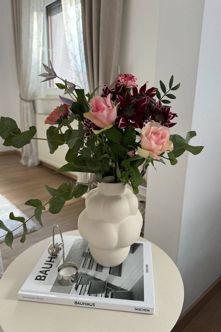 Aquí, el pequeño jarrón blanco Balloon de Louise Roe con un ramo de flores sobre una mesa en casa de @Merve Tengör.