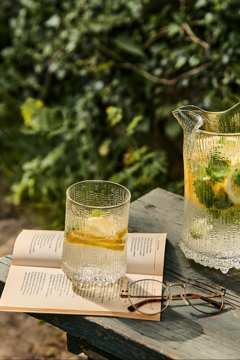 Summer Breeze es un cóctel sin alcohol con limón y menta, servido aquí en el jardín en un vaso alto Ultima Thule de Iittala.